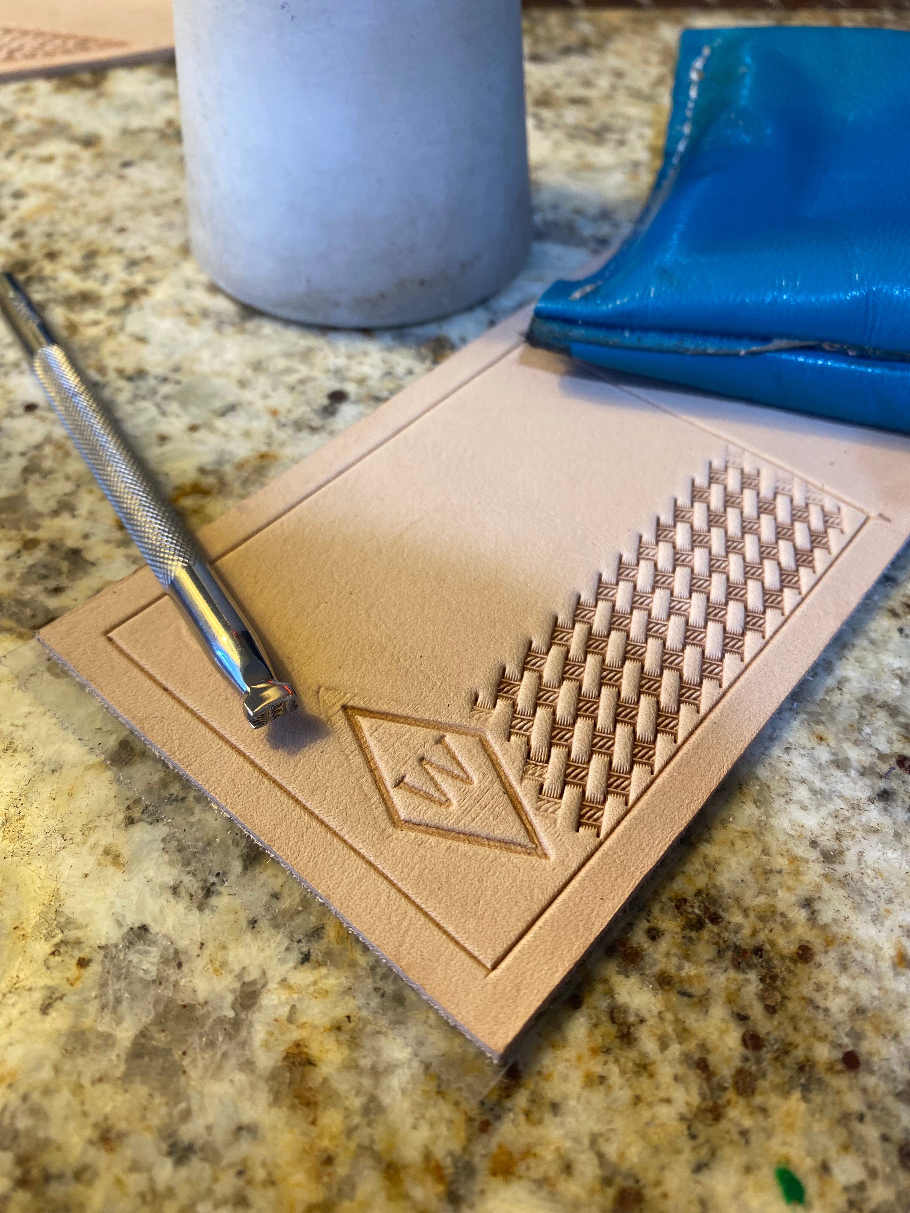 Basket Stamping the cover of a money clip wallet.